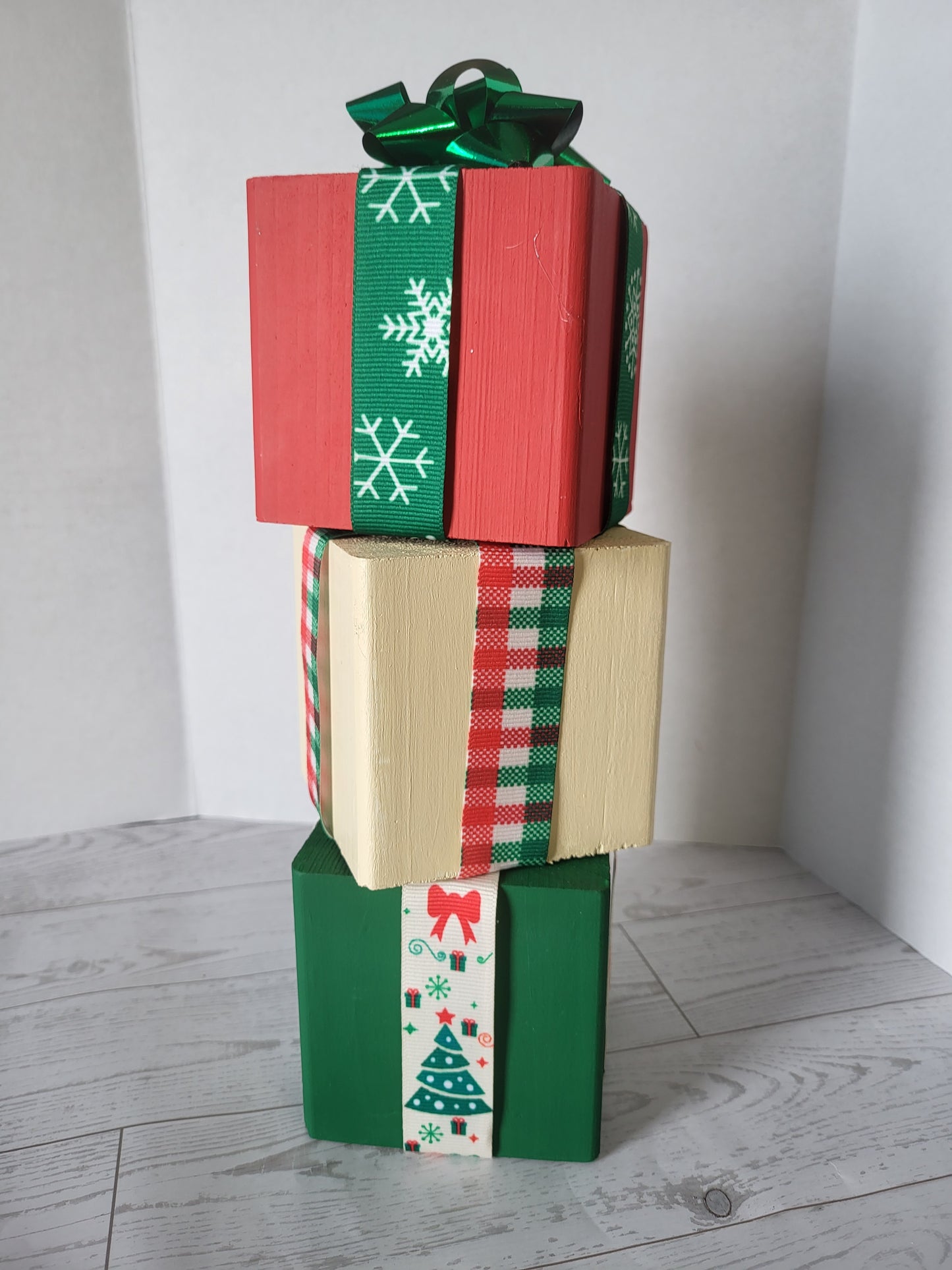 christmas gifts made of stacked wood cubes decorated with ribbons and a bow