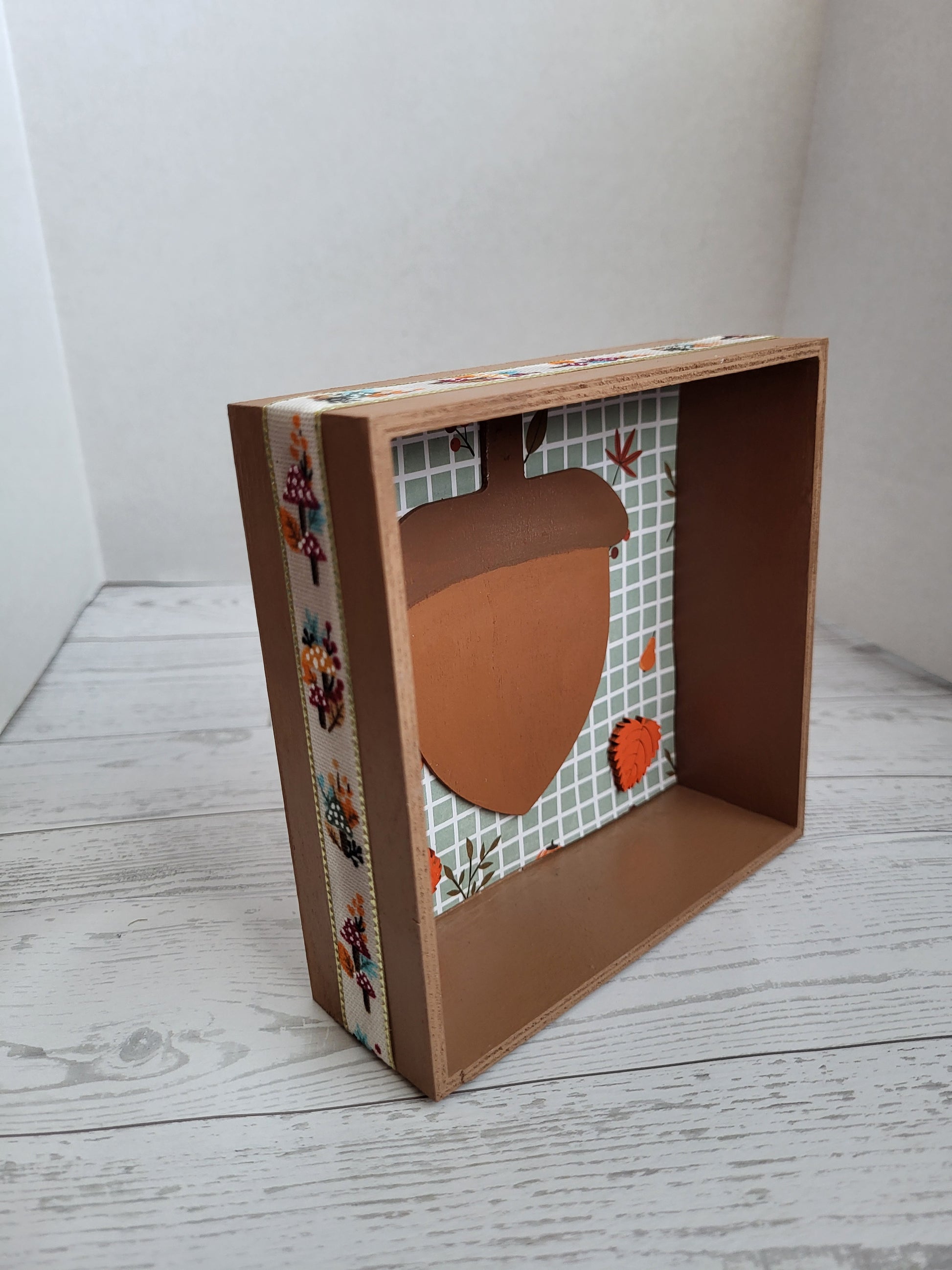 Fall shelf décor - wooden shadow box with acorn, leaves, and fall background