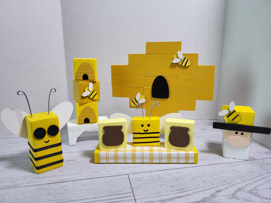 Hand-painted wooden bee shelf sitters for summer tiered trays and farmhouse displays—bright yellow and black accents with rustic seasonal charm.