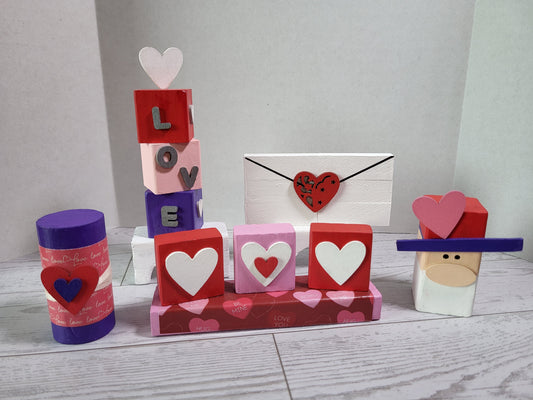 Hand-painted wooden Valentine shelf sitters with festive holiday designs—perfect for mantels, tiered trays, and farmhouse holiday décor.